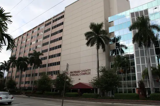 Mid-century concrete county courthouse tower with rows of narrow windows.