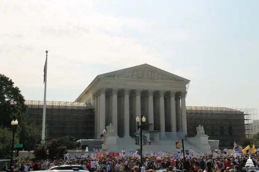 West front of the United States Supreme Court building, columns and pediment under a clear sky.