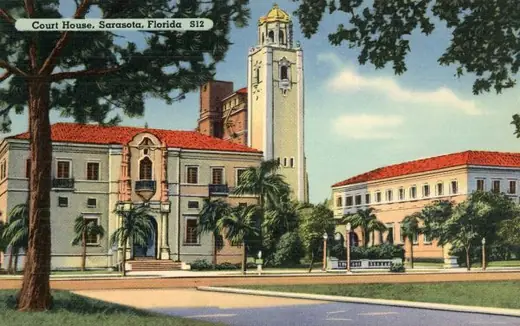 An archival photograph of the Sarasota County courthouse building and its grounds.